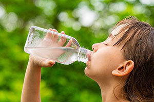 boy-drinking-water-outdoors-resized
